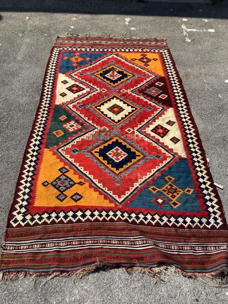 A Kelim polychrome flatweave carpet (worn), approx. 150 x 300cm